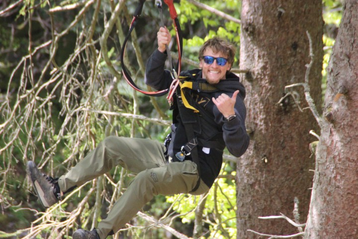 a man standing next to a tree